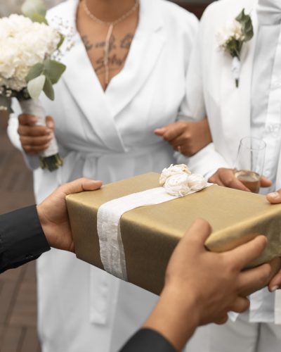 lesbian-couple-accepting-gifts-from-guests-their-wedding